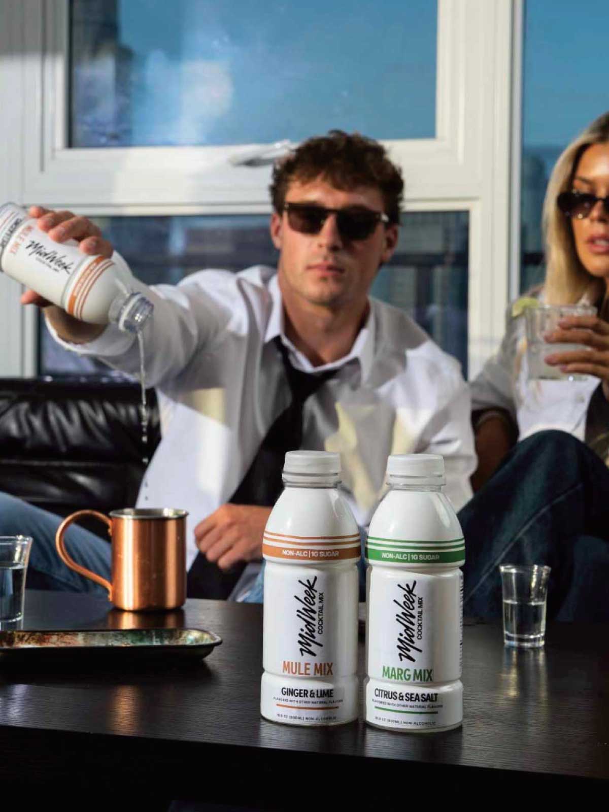 Two people enjoying Midweek Cocktail Mixers, Mule and Marg.