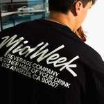Man wearing a black t-shirt with white text