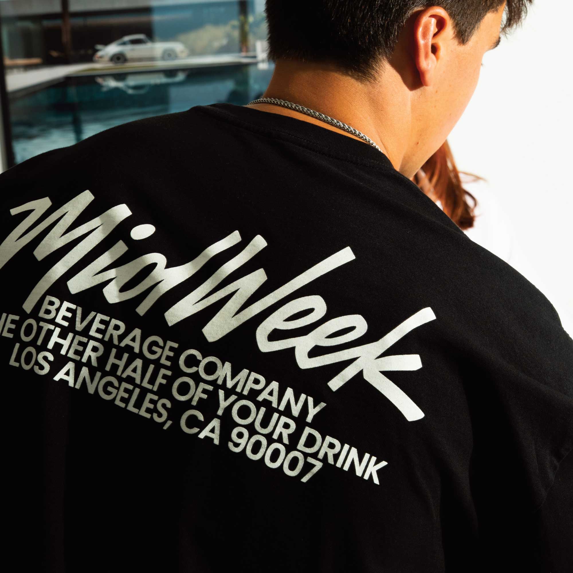 Man wearing a black t-shirt with white text