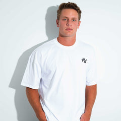 Man wearing a white Midweek t-shirt on a light gray background